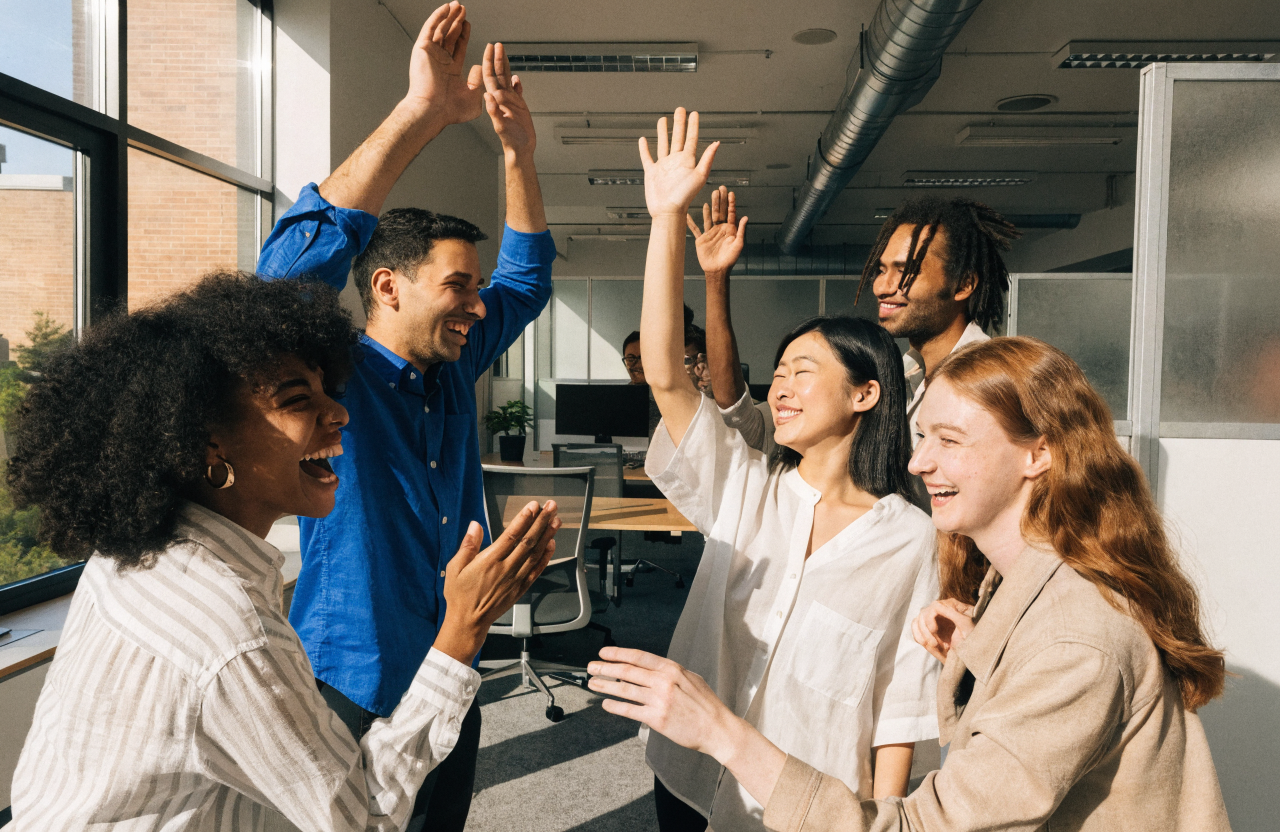 A team celebrating together in a bright modern office